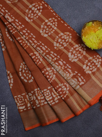 Pure linen saree dark mustard with batik butta prints and silver zari woven border
