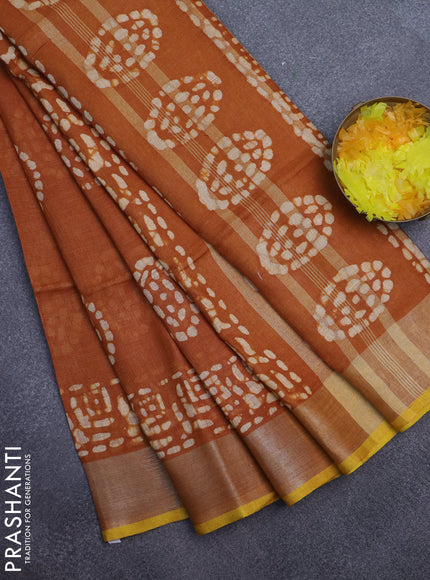Pure linen saree dark mustard with batik butta prints and silver zari woven border