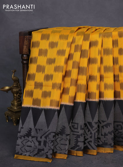 Ikat soft silk saree mustard yellow and black with allover ikat weaves and long silver zari woven border
