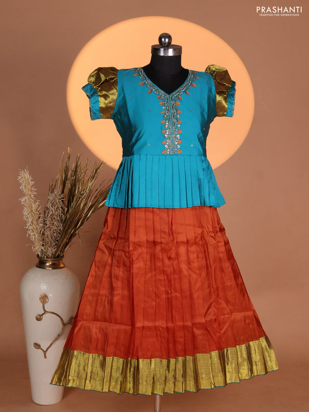 Silk kids lehenga teal blue shade and rust shade with aari work neck pattern & puff sleeve and zari woven border