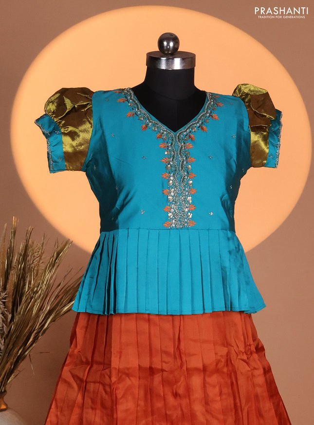 Silk kids lehenga teal blue shade and rust shade with aari work neck pattern & puff sleeve and zari woven border