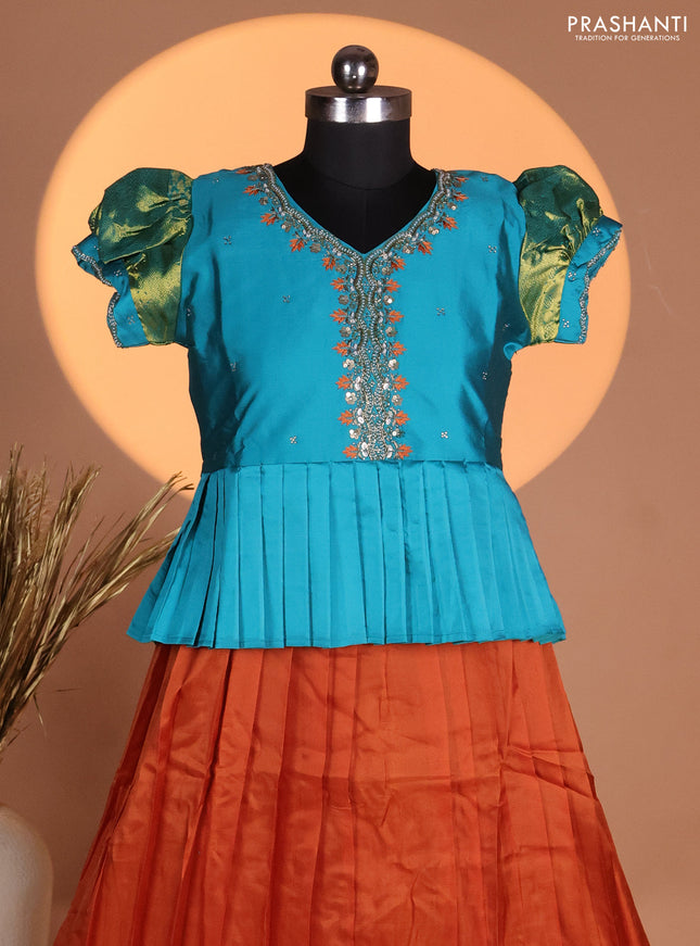 Silk kids lehenga teal shade and rust shade with aari work neck pattern & puff sleeve and zari woven border