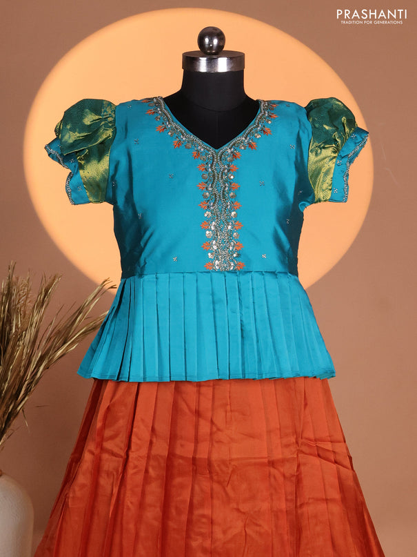 Silk kids lehenga teal shade and rust shade with aari work neck pattern & puff sleeve and zari woven border