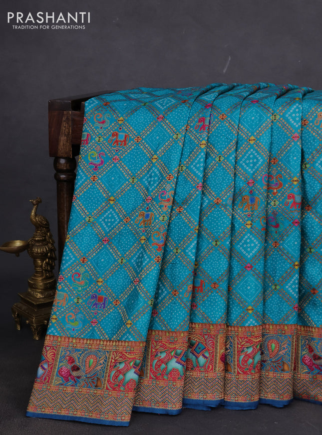 Banarasi silk saree teal blue and peacock blue with allover position prints and printed border