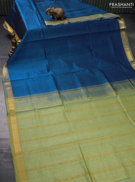 Silk cotton saree peacock blue and pastel green shade with plain body and zari woven border