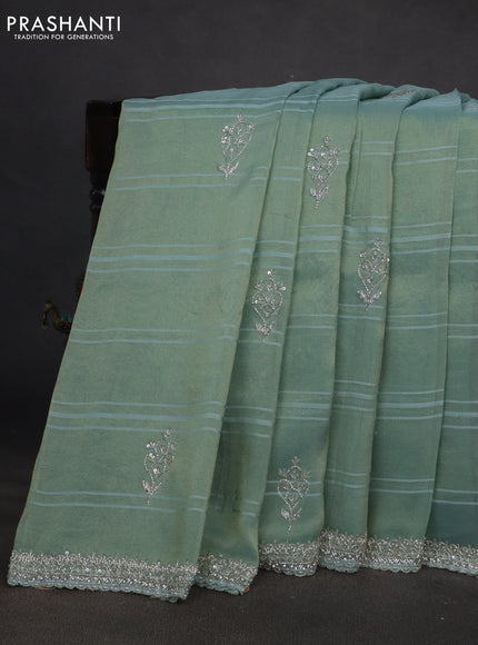 Tissue silk saree teal blue with embroidery work buttas and sequin & beaded work border