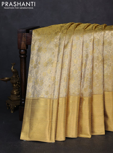 Pure kanchipuram tissue silk saree gold with allover zari woven floral brocade weaves and rich zari woven border