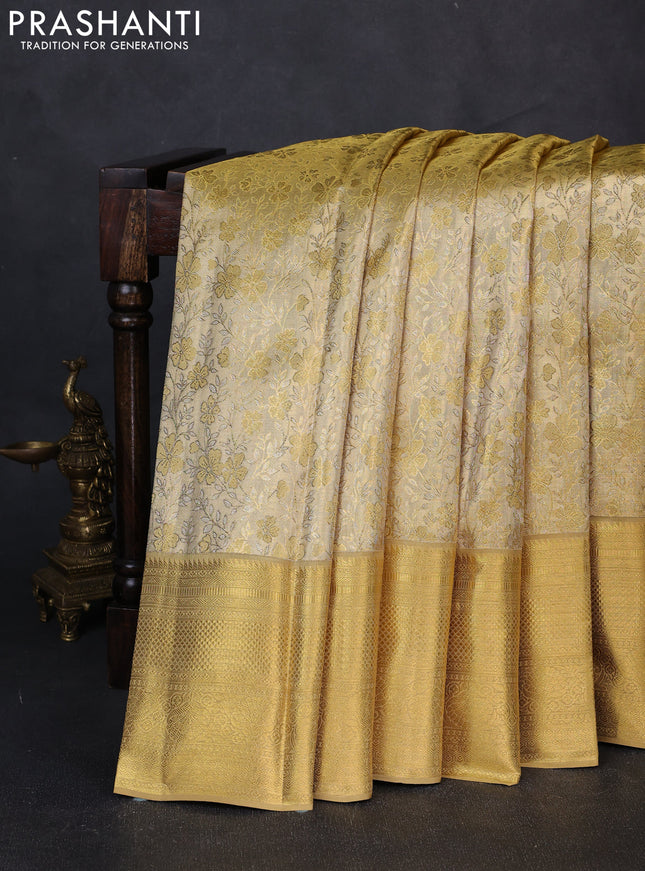 Pure kanchipuram tissue silk saree gold with allover zari woven floral brocade weaves and rich zari woven border