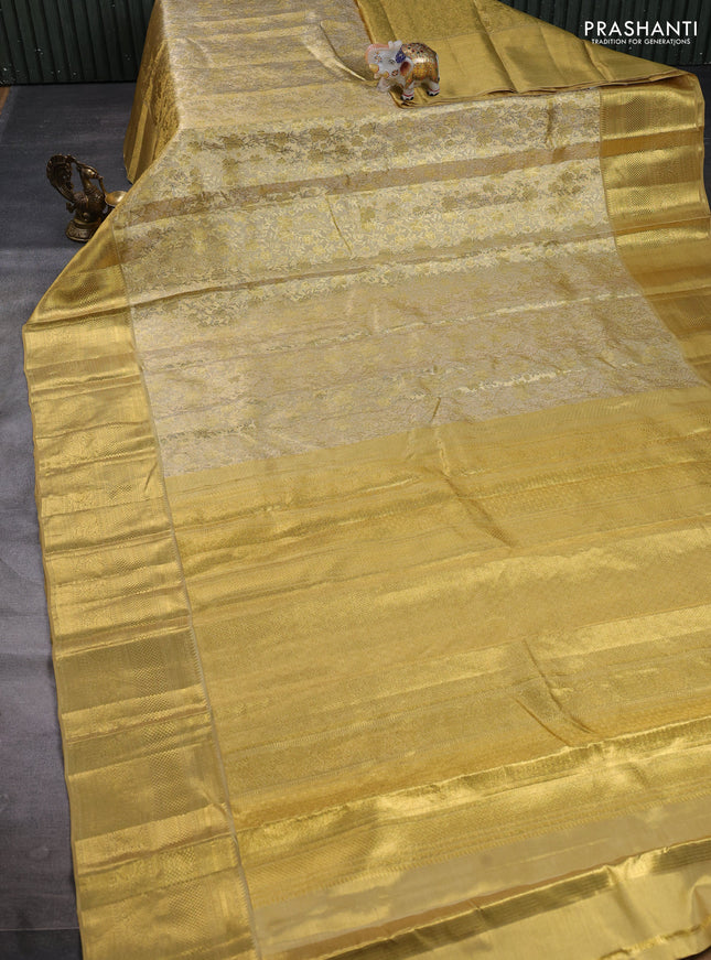 Pure kanchipuram tissue silk saree gold with allover zari woven floral brocade weaves and rich zari woven border