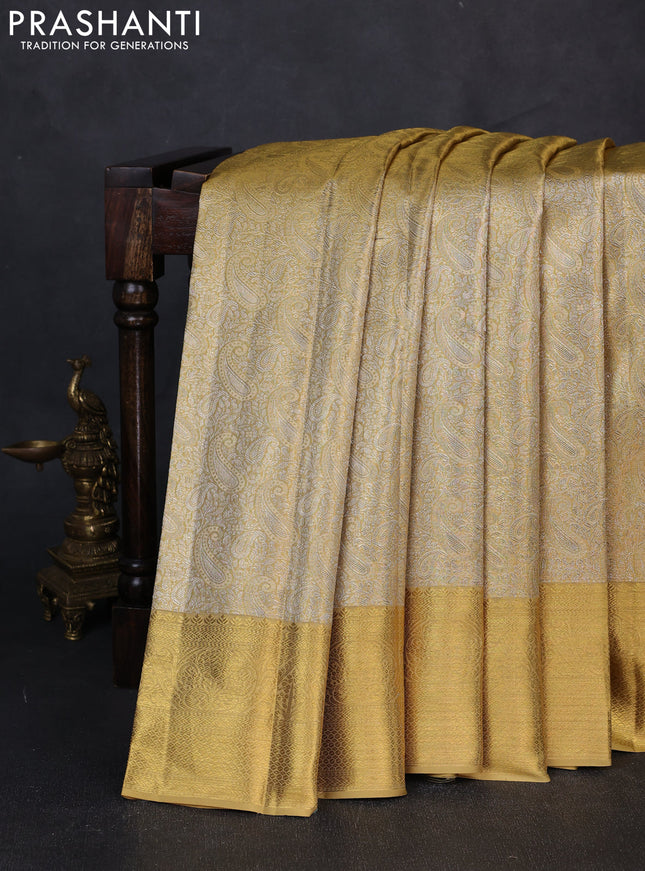 Pure kanchipuram tissue silk saree gold with allover zari woven paisley brocade weaves and rich zari woven border
