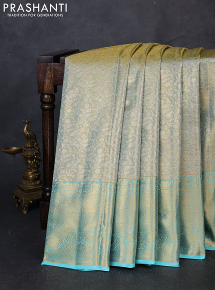 Pure kanchipuram tissue silk saree dual shade of gold and teal blue with allover zari woven brocade weaves and long rich zari woven border
