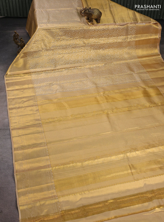 Pure kanchipuram tissue silk saree gold with allover zari woven brocade weaves and long rich zari woven border