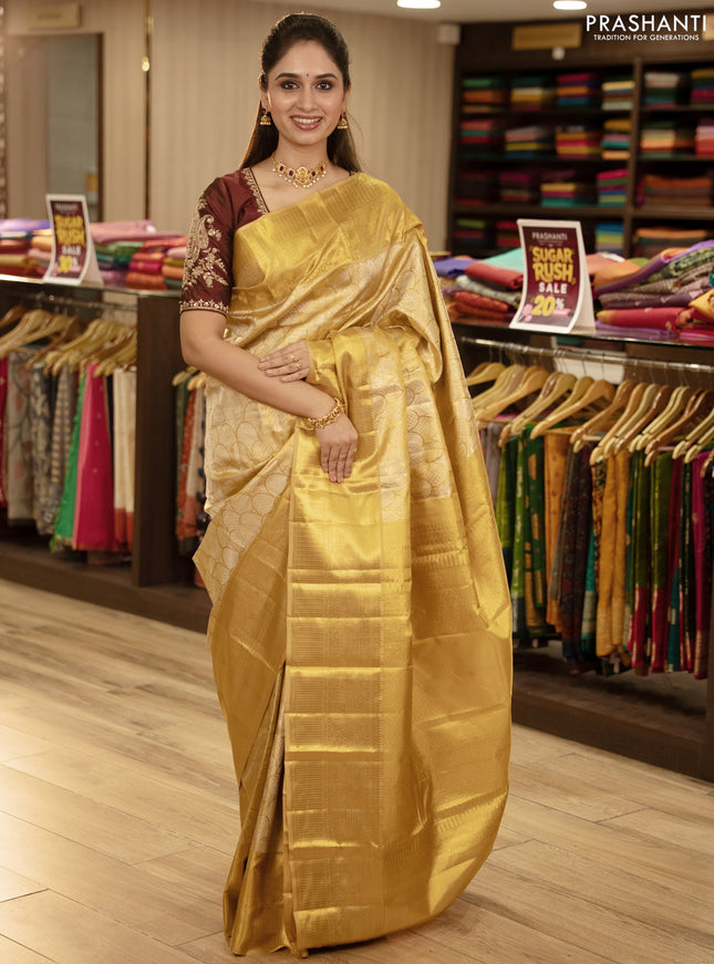 Pure kanchipuram tissue silk saree gold with allover zari woven brocade weaves and rich zari woven border