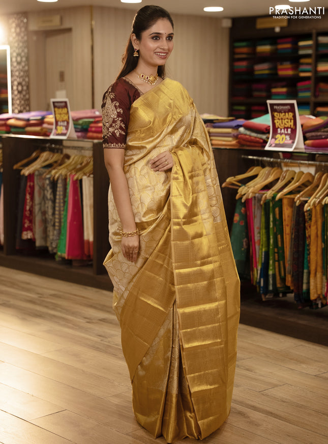 Pure kanchipuram tissue silk saree gold with allover zari woven brocade weaves and rich zari woven border
