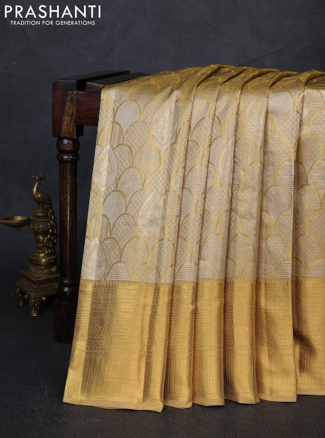 Pure kanchipuram tissue silk saree gold with allover zari woven brocade weaves and rich zari woven border