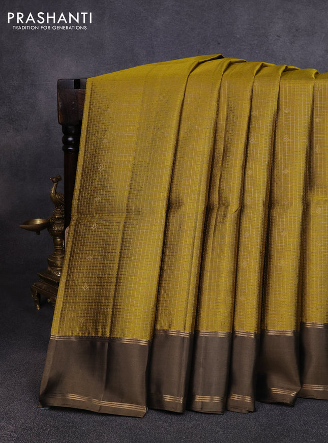 Pure soft silk saree mehendi green and datk olive green with allover small zari checks & buttas and rettapet zari woven border