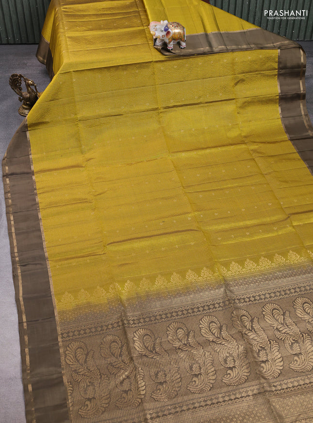 Pure soft silk saree mehendi green and datk olive green with allover small zari checks & buttas and rettapet zari woven border