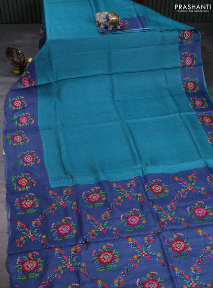 Pure tussar silk saree teal green and blue with allover zari woven buttas and floral embroidery butta border