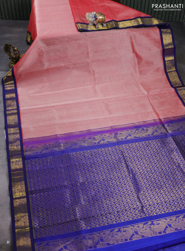 Silk cotton saree peach orange and navy blue with plain body and zari woven korvai border
