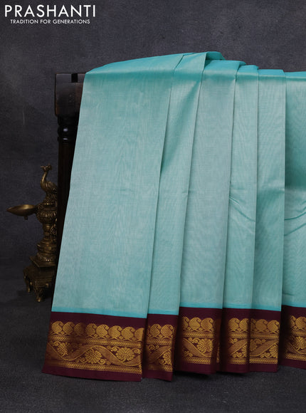 Silk cotton saree teal green and deep wine with plain body and zari woven korvai border