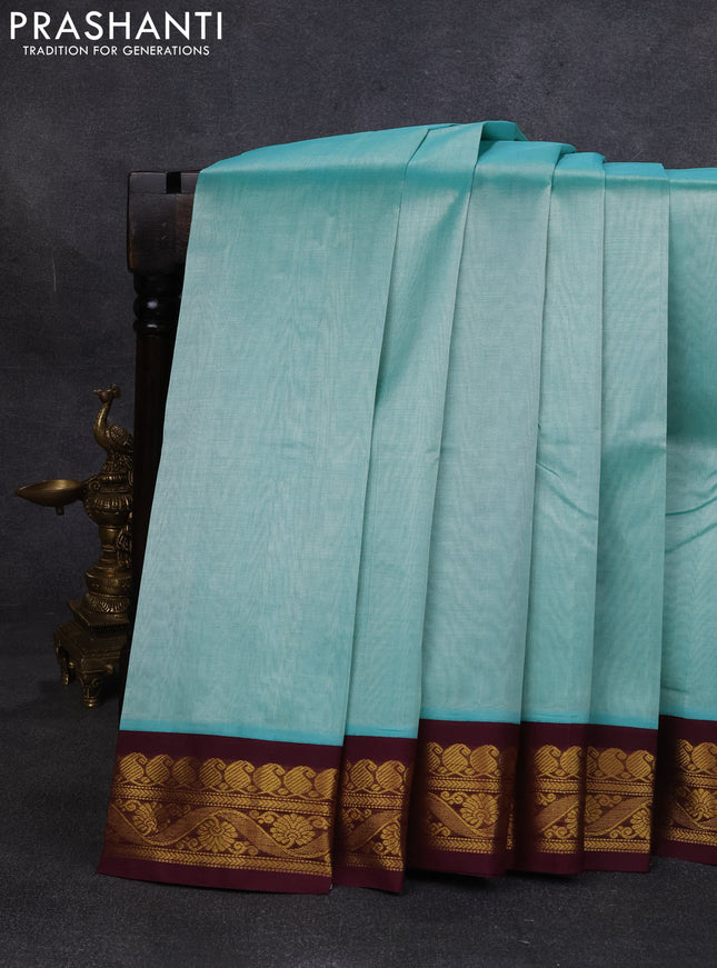 Silk cotton saree teal green and deep wine with plain body and zari woven korvai border