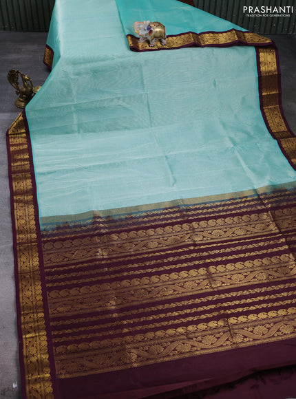 Silk cotton saree teal green and deep wine with plain body and zari woven korvai border