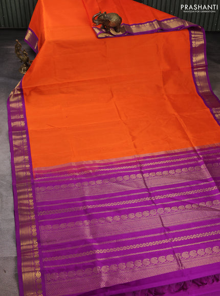 Silk cotton saree orange and purple with plain body and zari woven korvai border