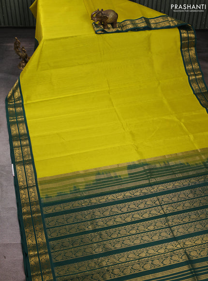 Silk cotton saree lime yellow and bottle green with plain body and zari woven korvai border