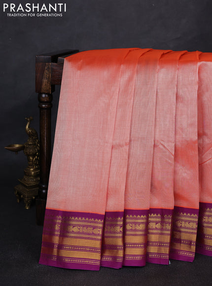 Silk cotton saree peach orange and purple with plain body and zari woven korvai border