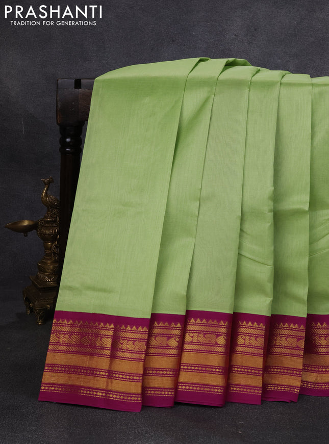 Silk cotton saree pista green and purple with plain body and zari woven korvai border