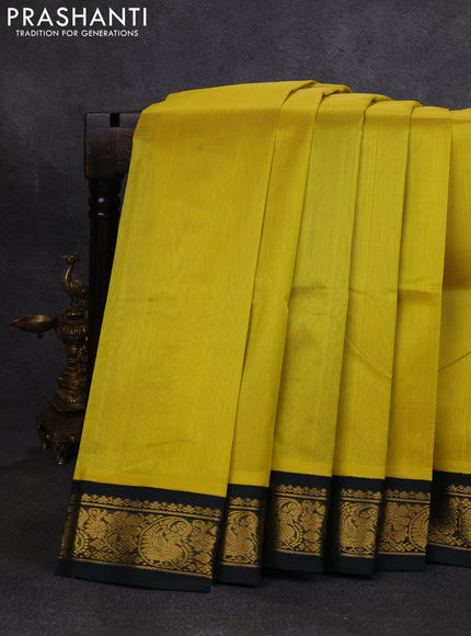 Silk cotton saree lime yellow and bottle green with plain body and paisley butta zari woven korvai border