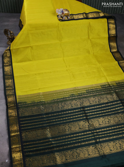 Silk cotton saree lime yellow and bottle green with plain body and paisley butta zari woven korvai border