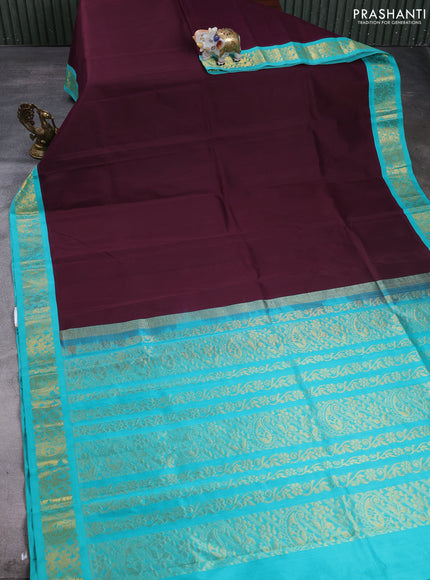 Silk cotton saree deep wine and teal green with plain body and paisley butta zari woven korvai border
