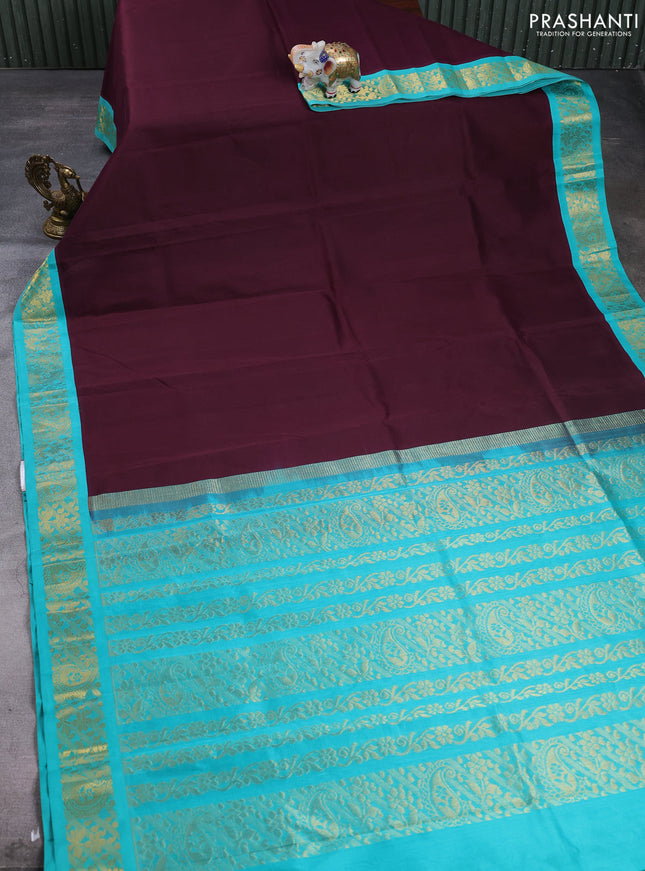 Silk cotton saree deep wine and teal green with plain body and paisley butta zari woven korvai border