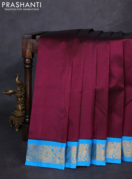Silk cotton saree deep wine and cs blue with plain body and paisley butta zari woven korvai border