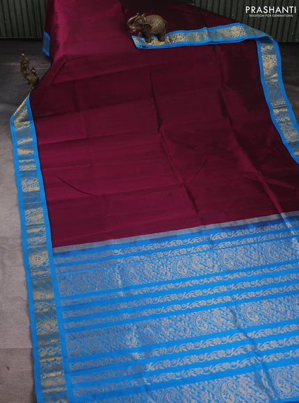 Silk cotton saree deep wine and cs blue with plain body and paisley butta zari woven korvai border