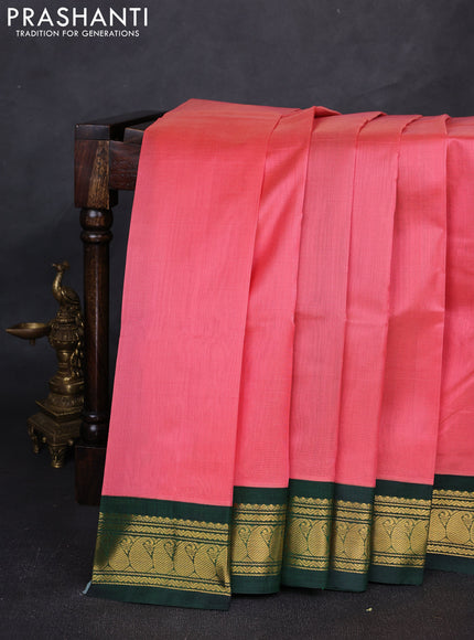 Silk cotton saree dark peach and bottle green with plain body and paisley zari woven korvai border