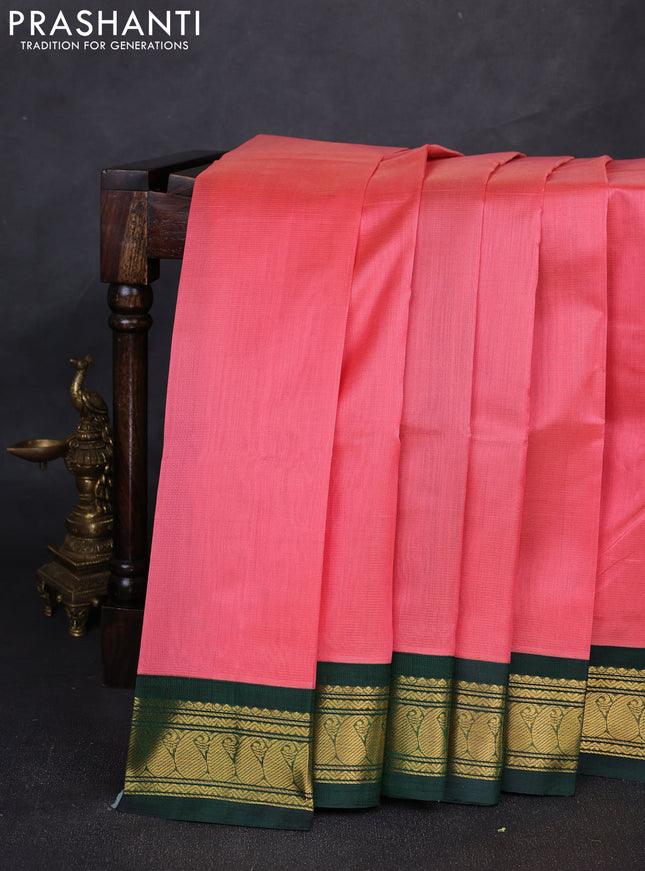 Silk cotton saree dark peach and bottle green with plain body and paisley zari woven korvai border