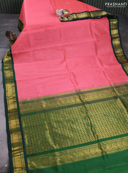 Silk cotton saree dark peach and bottle green with plain body and paisley zari woven korvai border