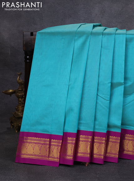 Silk cotton saree teal green and purple with plain body and paisley zari woven korvai border