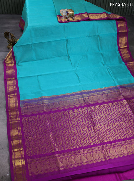 Silk cotton saree teal green and purple with plain body and paisley zari woven korvai border