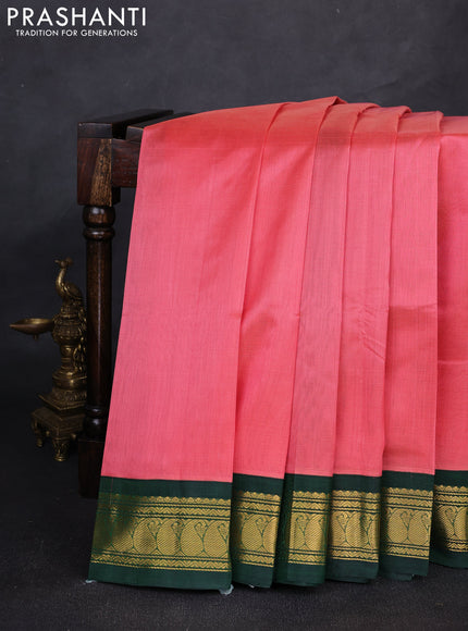 Silk cotton saree peach pink and bottle green with plain body and paisley zari woven korvai border