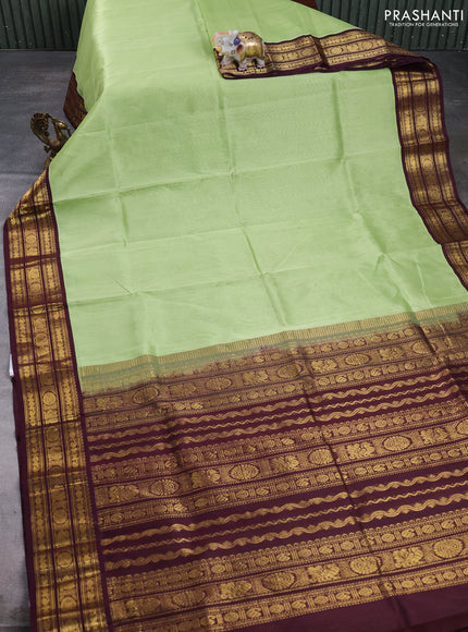 Silk cotton saree pista green and wine with plain body and zari woven butta korvai border
