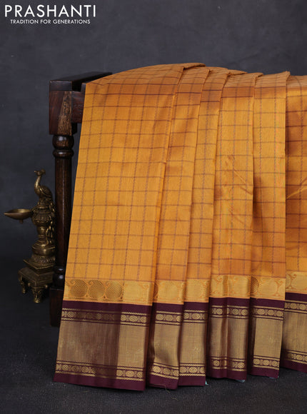 Silk cotton saree mustard yellow and deep maroon with allover thread checked pattern and paisley butta zari woven korvai border