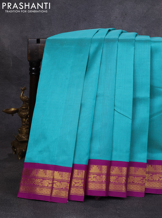 Silk cotton saree teal green and purple with plain body and temple design zari woven korvai border