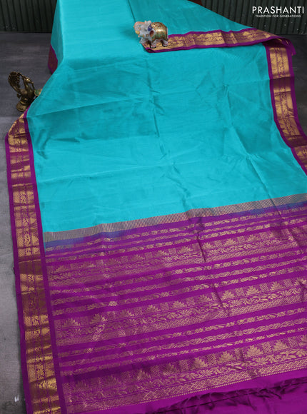 Silk cotton saree teal green and purple with plain body and temple design zari woven korvai border