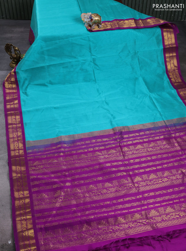 Silk cotton saree teal green and purple with plain body and temple design zari woven korvai border
