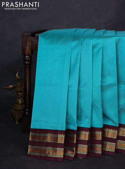 Silk cotton saree teal green and deep maroon with plain body and temple design zari woven korvai border