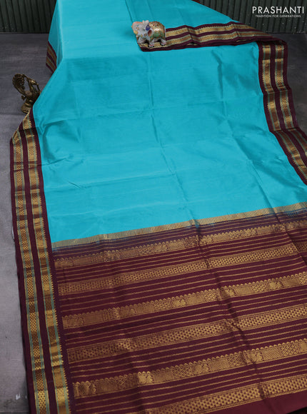 Silk cotton saree teal green and deep maroon with plain body and temple design zari woven korvai border
