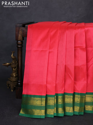 Silk cotton saree dark peach and green with plain body and zari woven korvai border